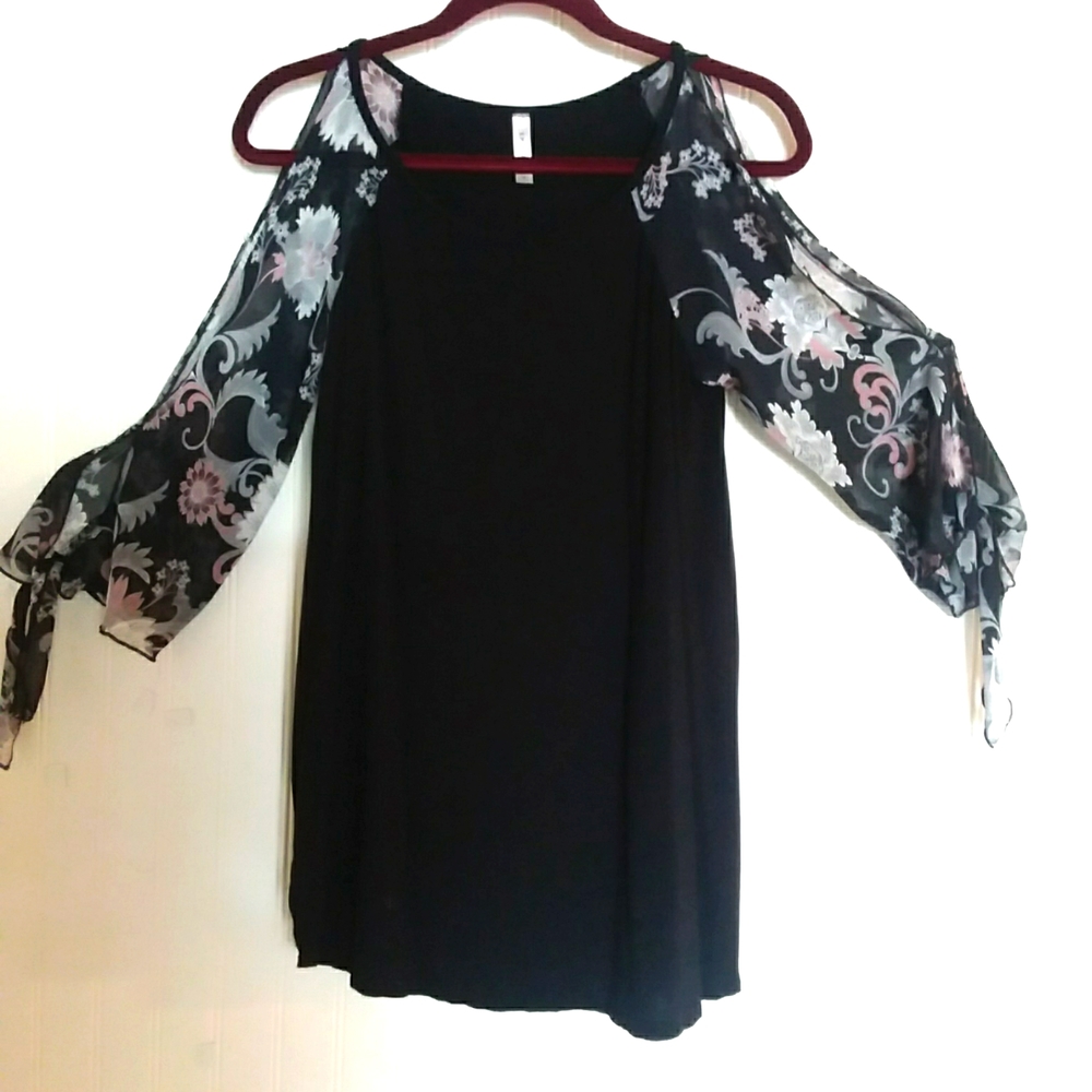 EMERALD top in size medium.  Black with sheer peek a boo sleeves.  Cute!